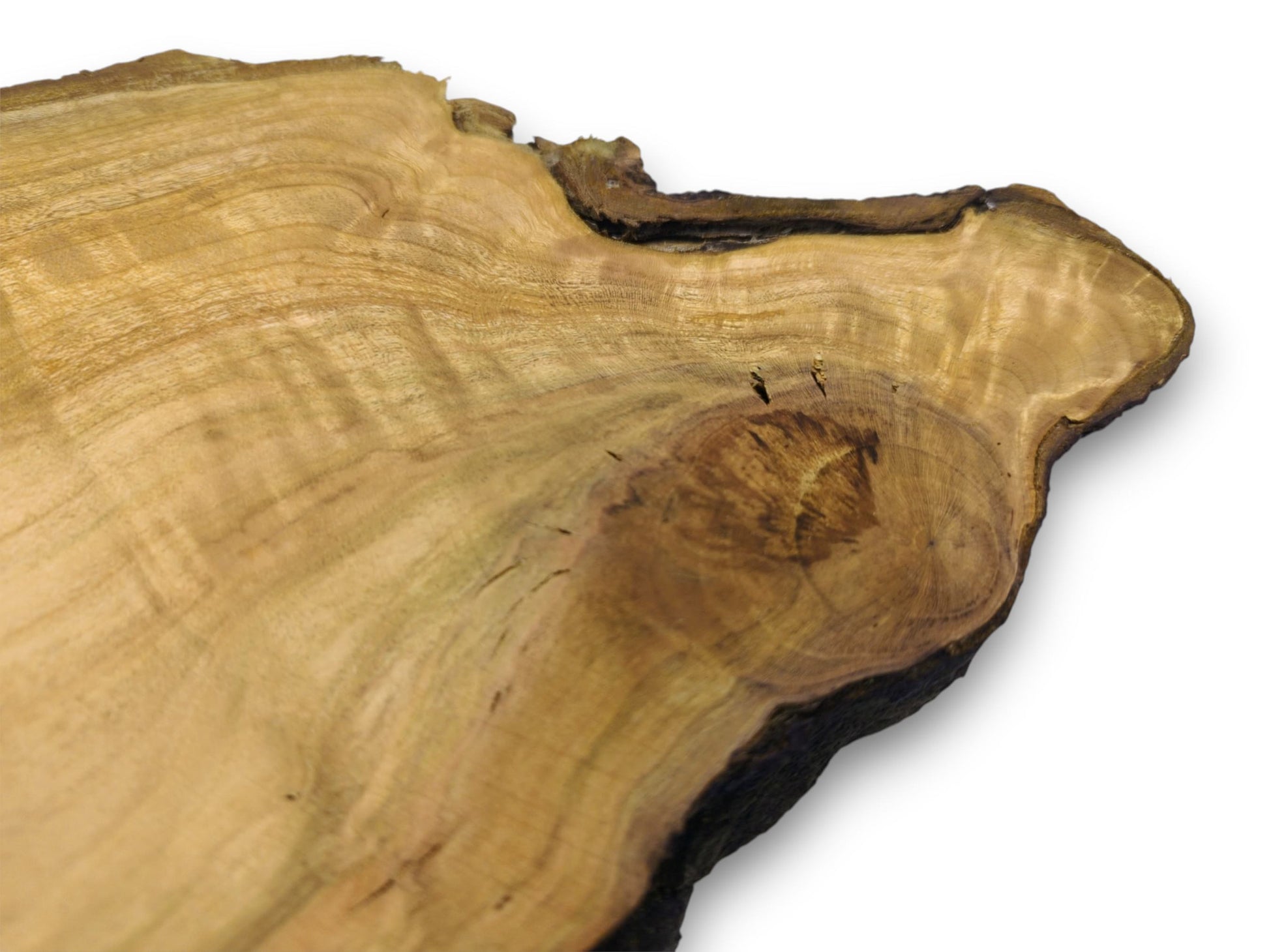 A close-up on a wild cherry slab's surface, showing flowing grain around a dark, central knot.
