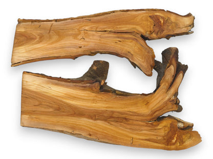 Two raw wild cherry wood slabs are arranged horizontally, highlighting their organic, bark-lined live edges.