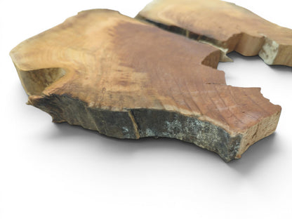 Two irregular cherry wood slices with natural edges, visible growth rings, and a rough texture.