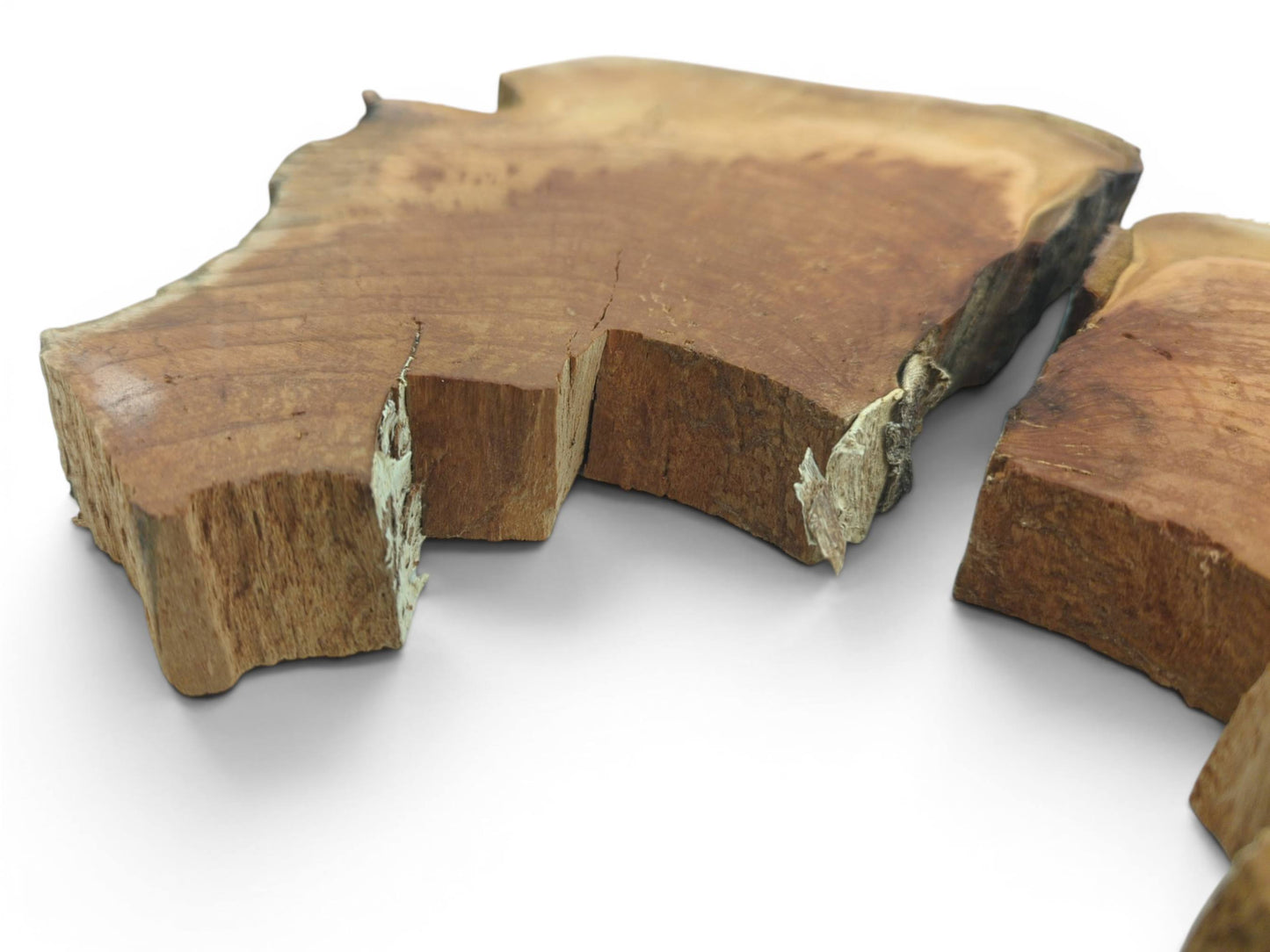 Two irregular cherry wood slices with natural edges, visible cracks, and a rough texture.