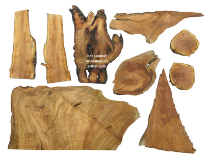 Various shapes and sizes of cherry wood pieces with live edges and visible grain.