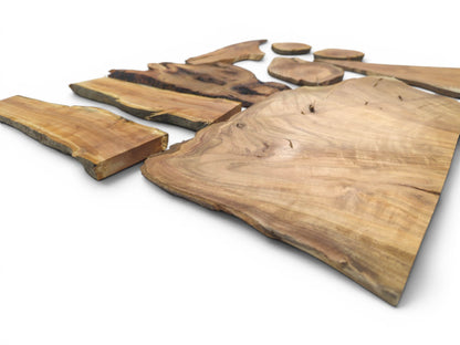 An overhead view of multiple cherry wood slices with live edges and visible grain.