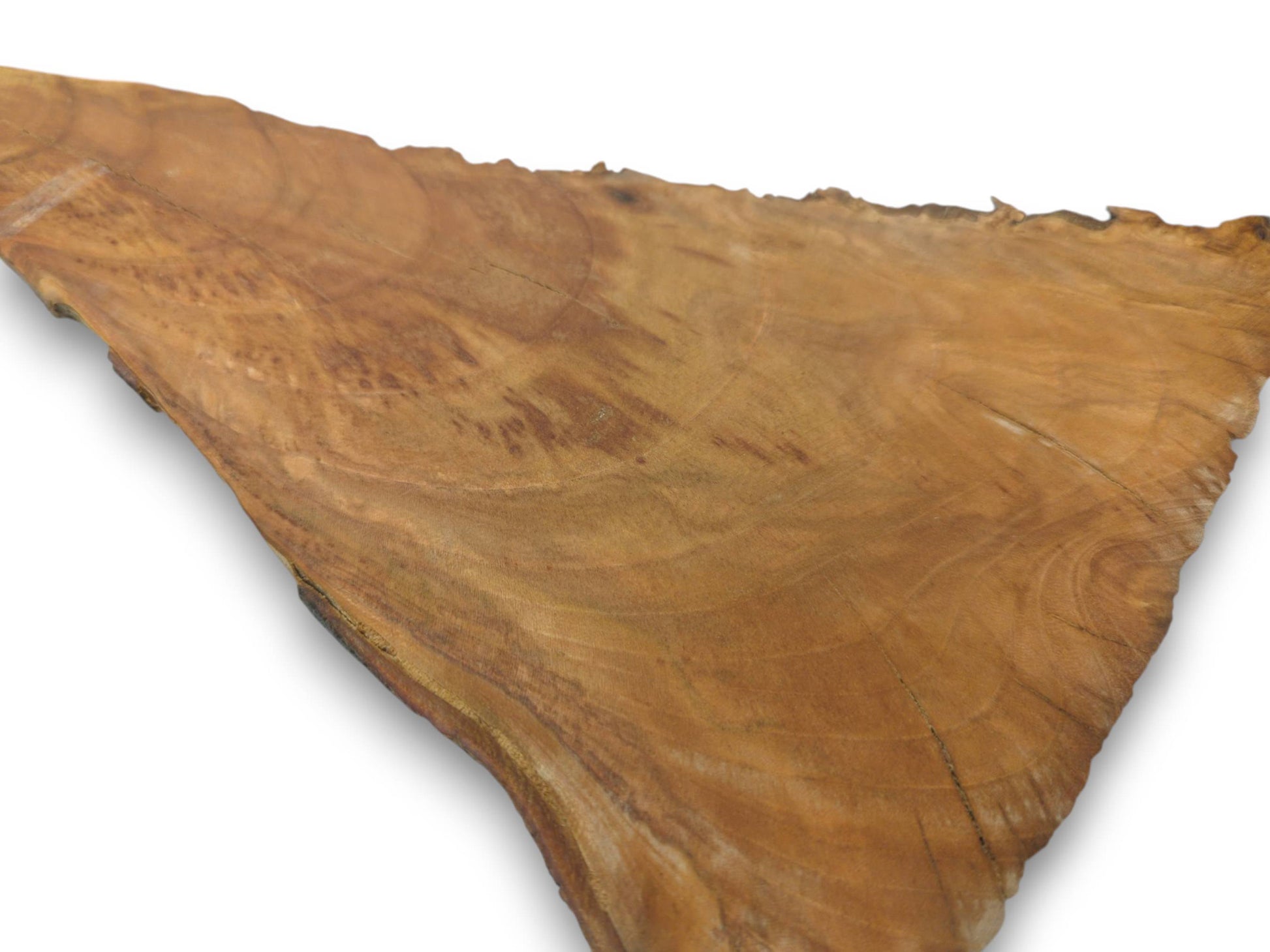 An overhead view of a single cherry wood slice with a live edge and visible growth rings.