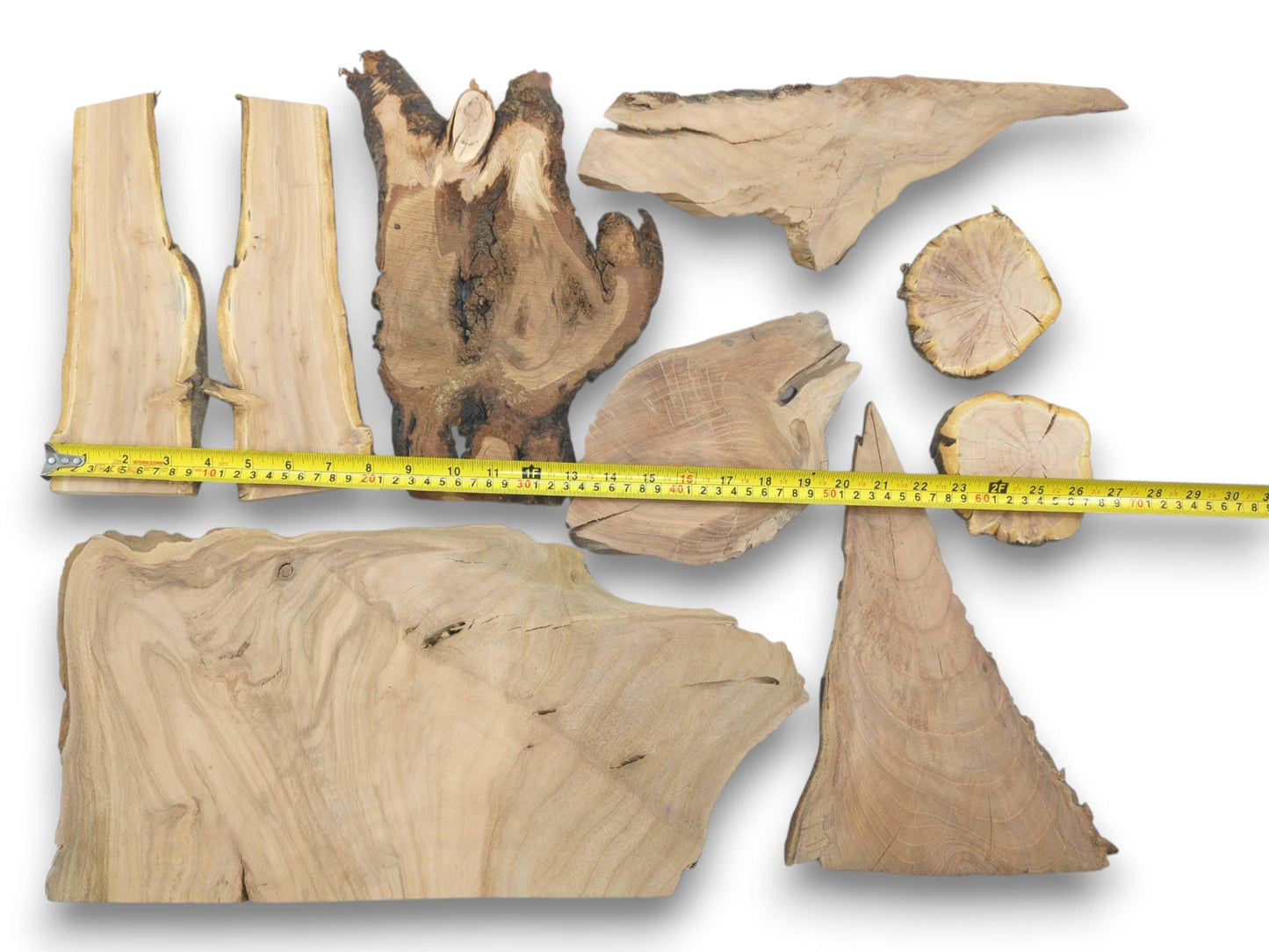 Overhead view of nine varied cherry wood pieces with live edges and natural grain patterns.