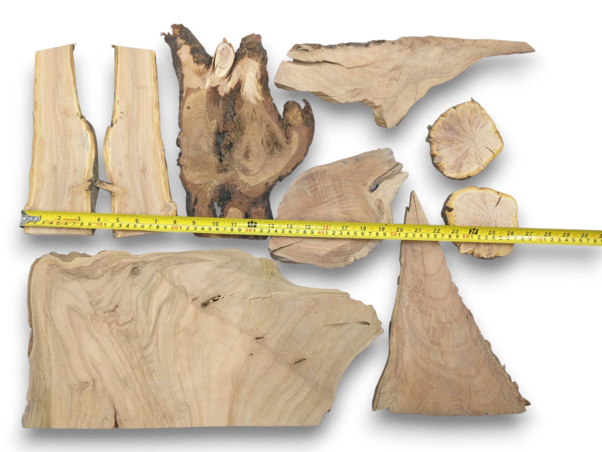 Overhead view of nine varied cherry wood pieces with live edges and natural grain patterns.