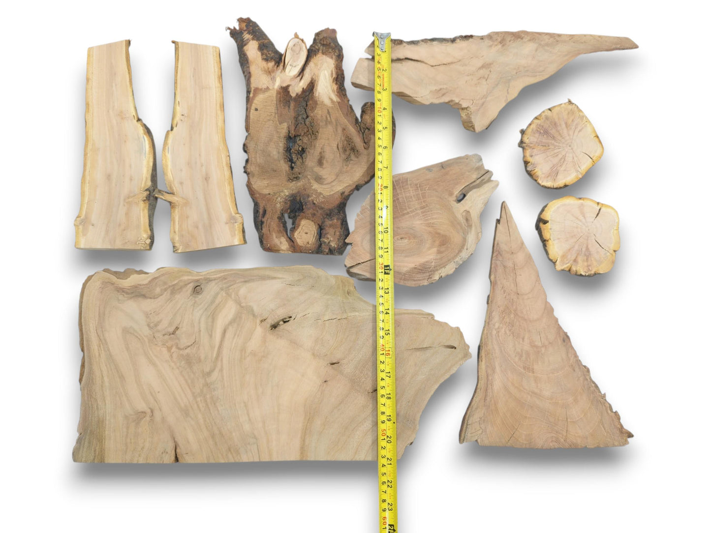 Overhead view of nine varied cherry wood pieces with live edges and natural grain patterns.