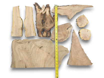 Overhead view of nine varied cherry wood pieces with live edges and natural grain patterns.