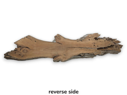 The reverse side of a cherry wood slab with a live edge and natural texture.