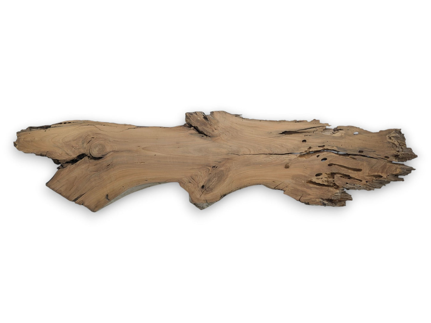 A light brown cherry wood slab with a live edge, cracks, and many holes.