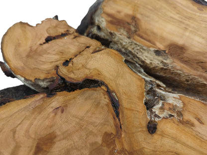 Close-up of a wild cherry wood slab, showing natural grain, dark bark, and rough texture.