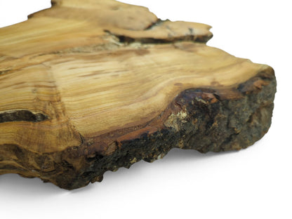 Close-up of a wild cherry wood slab with a live edge and visible growth rings.
