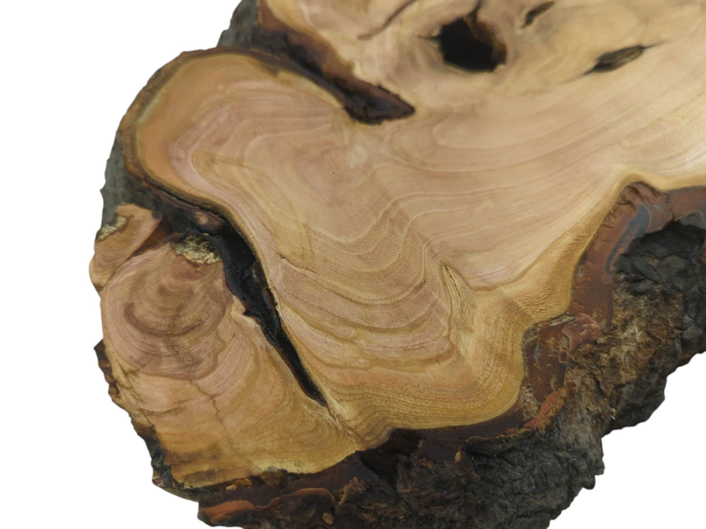 Close-up of a wild cherry wood slab with natural bark edges and visible wood grain.