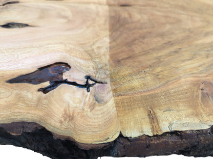 Close-up of a wild cherry wood slab with a large dark knot and natural grain.