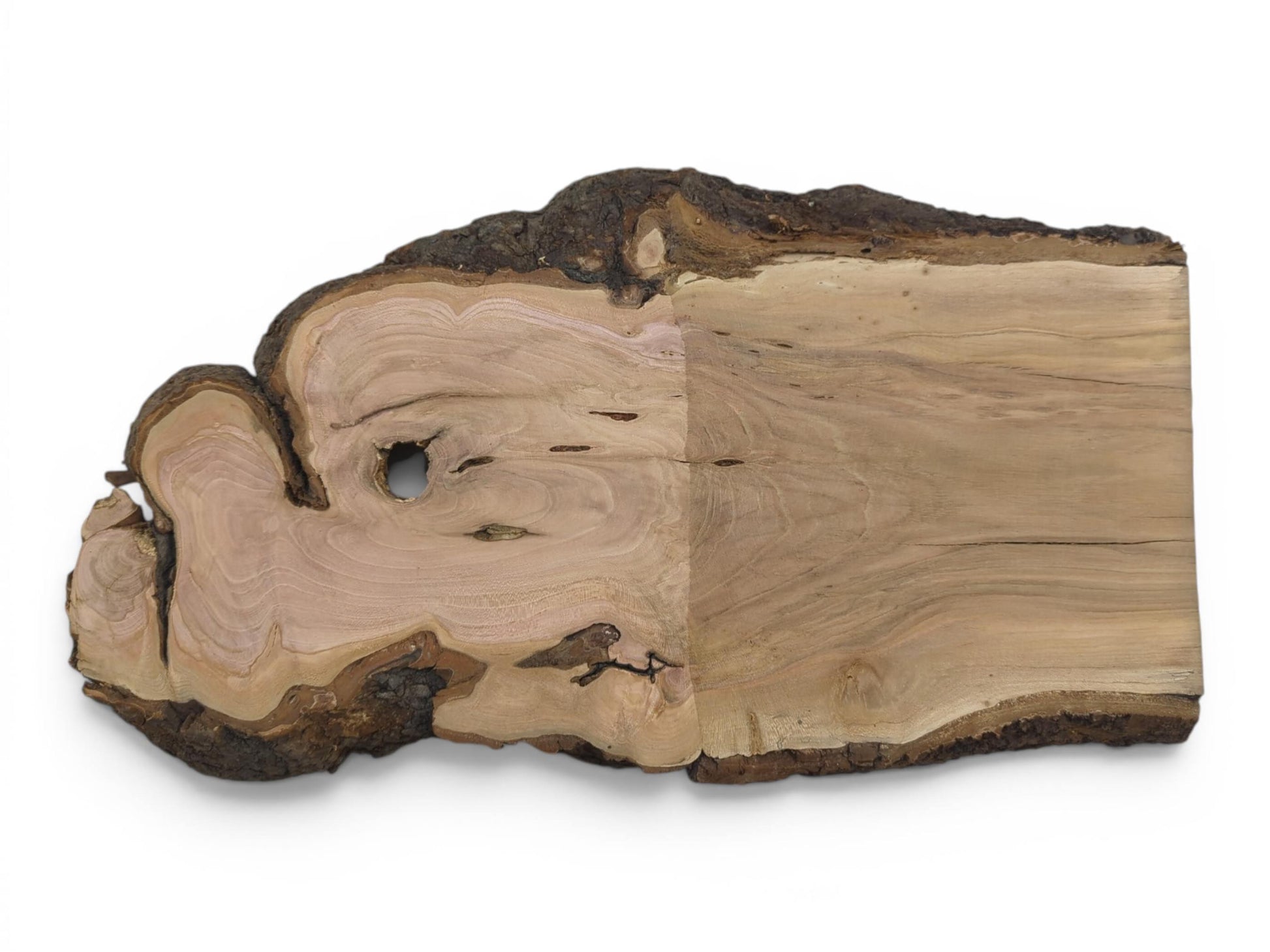 A light brown wild cherry wood slab with a live edge and a natural hole.