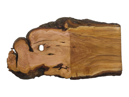 A light brown wild cherry wood slab with a live edge and a natural hole.