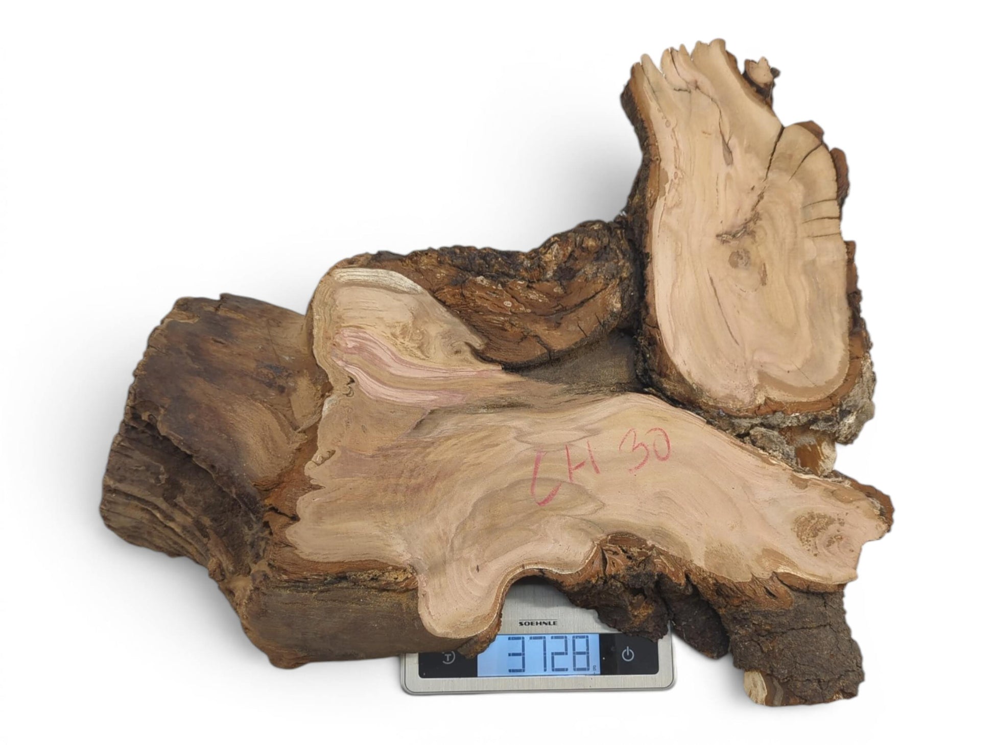 An irregularly shaped wild cherry wood slab with natural bark edges on a white background.
