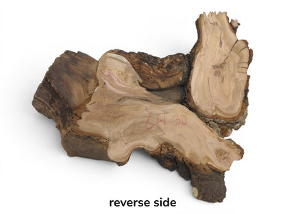 Reverse side of a wild cherry wood slab with natural bark edges and visible grain.