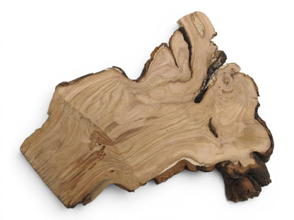 An irregularly shaped wild cherry wood slab with natural bark edges on a white background.