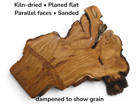 A kiln-dried, planed, sanded, and parallel-faced wild cherry wood slab with live edges.