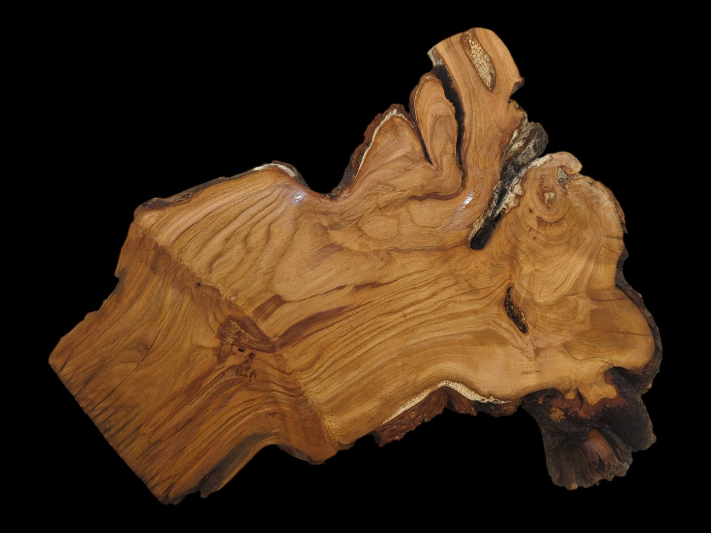 A large, irregularly shaped wild cherry wood slab with a smooth surface and live edges.