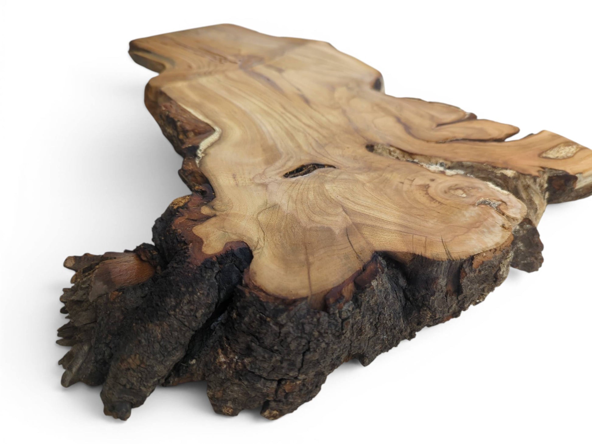 An irregularly shaped wild cherry wood slab with a smooth surface and dark, textured bark.