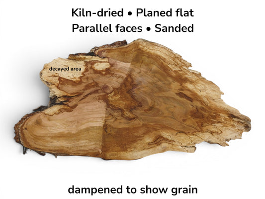 An irregularly shaped, kiln-dried wild cherry wood slab with a decayed area and visible grain.