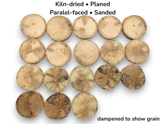 An overhead view of eighteen wood cookies, with lower rows showing dark, complex spalted patterns.