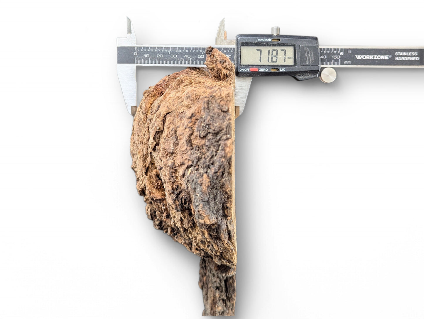 Digital caliper measures an irregular, untreated wood blank with dark brown bark texture, displaying 71.87 mm.