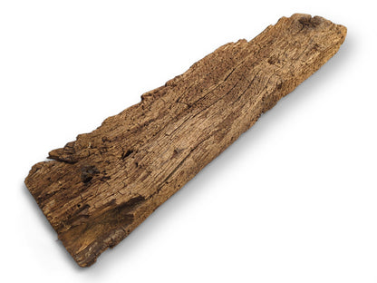 A weathered, dark brown wooden plank fragment with deeply textured, cracked, and visibly flaking surface.