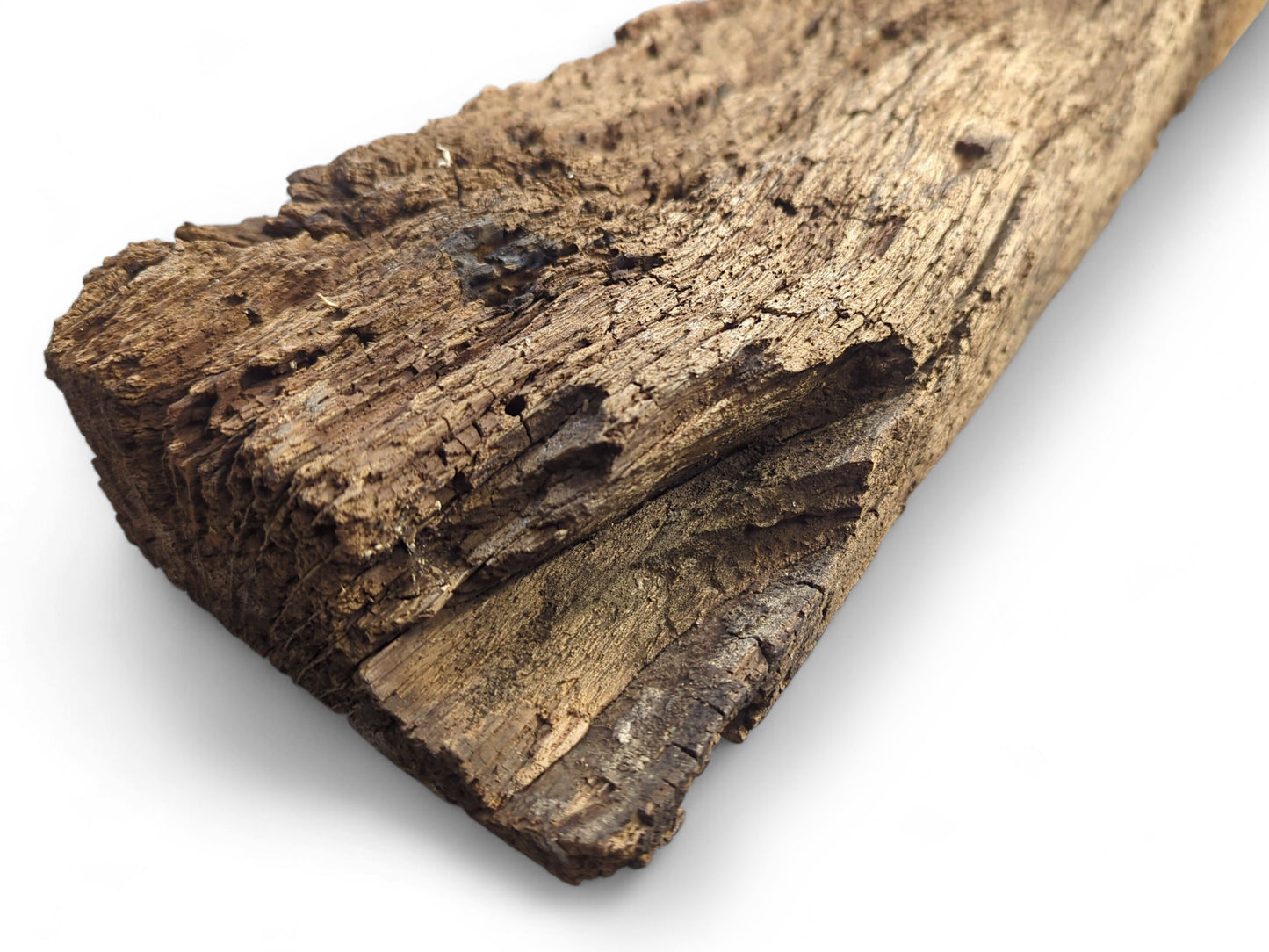 Time-worn, dark brown reclaimed wood beam fragment showing a deeply cracked, flaking, and crumbly surface.