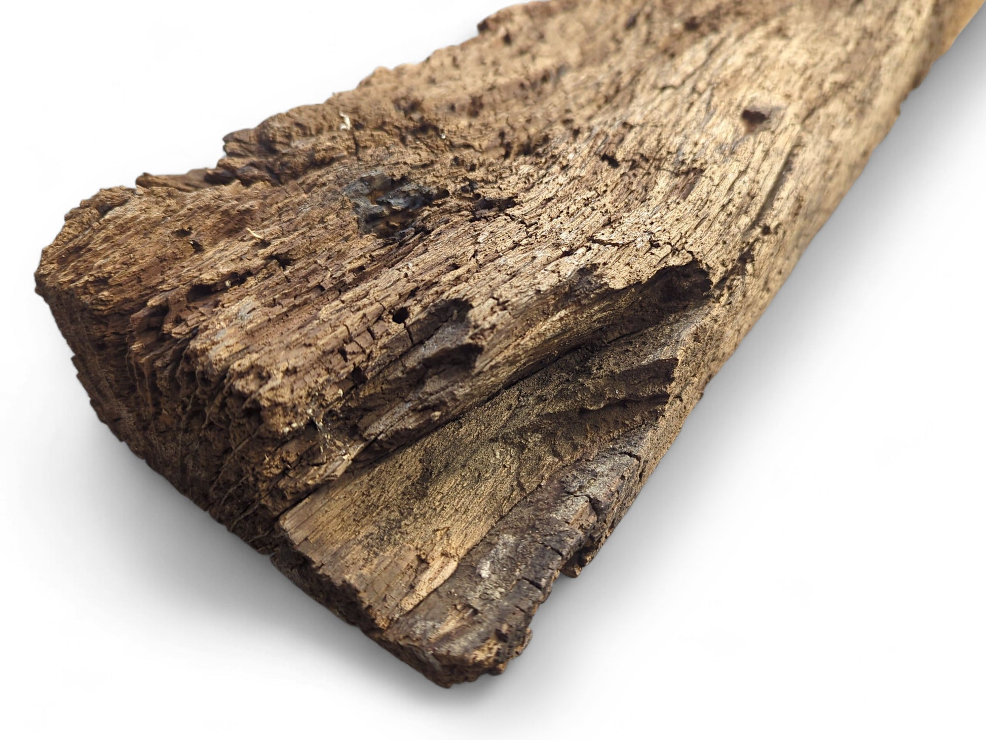 Time-worn, dark brown reclaimed wood beam fragment showing a deeply cracked, flaking, and crumbly surface.