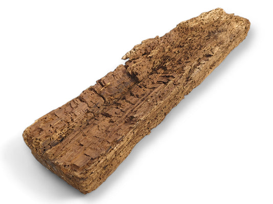 Rough, untreated, naturally weathered brown wood beam fragment with a fragile, flaking, and heavily textured surface.