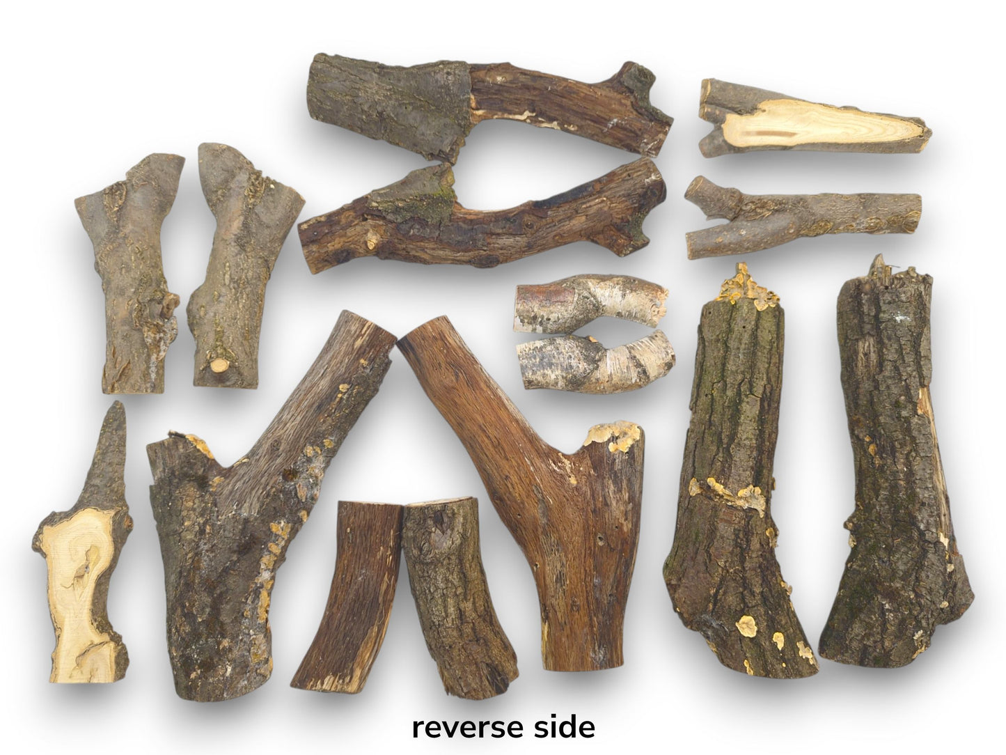 An arrangement of split wood halves displaying their reverse, bark-covered sides in various natural shapes.