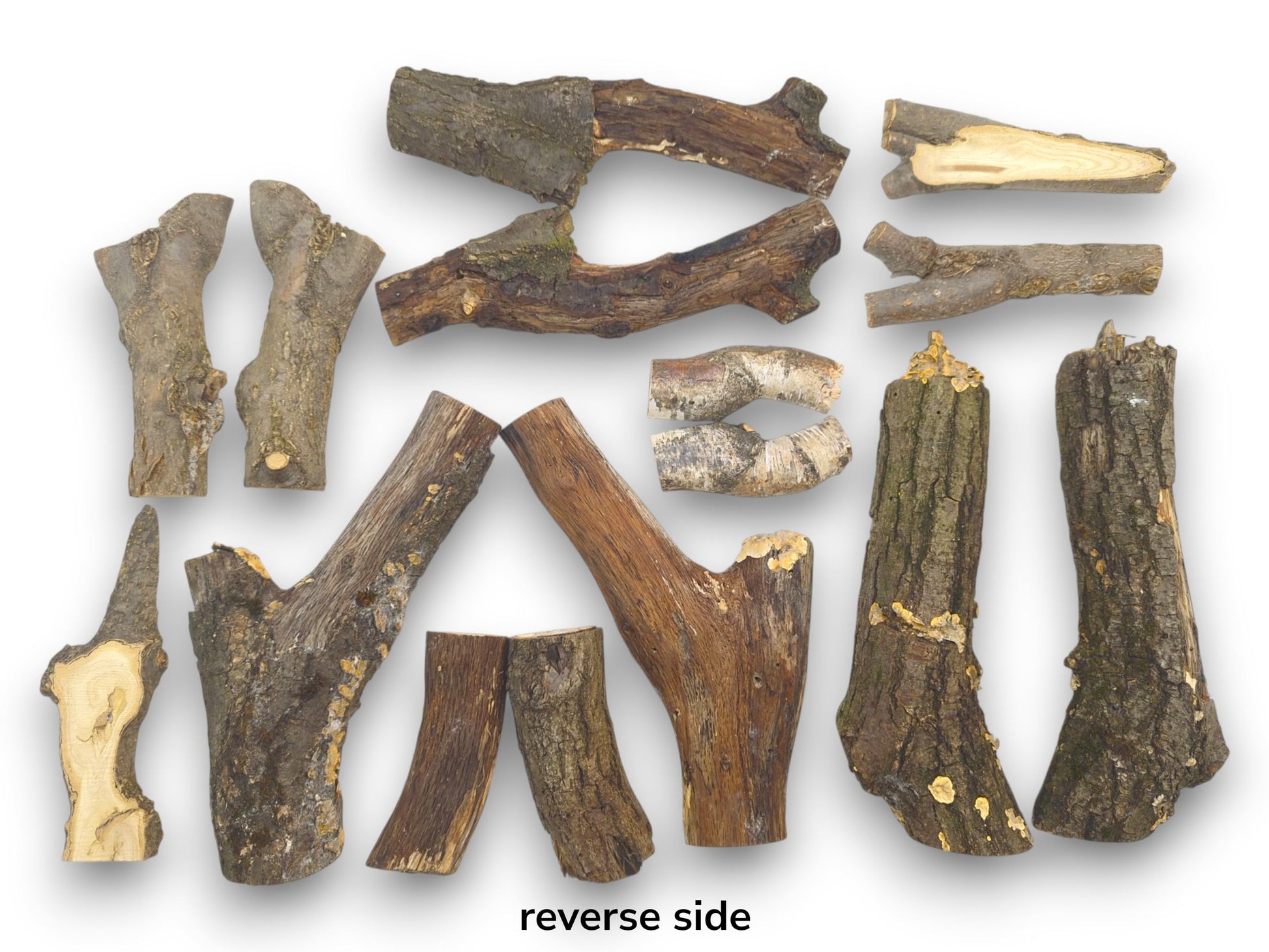 An arrangement of split wood halves displaying their reverse, bark-covered sides in various natural shapes.