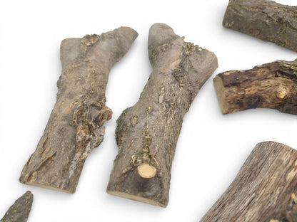 Multiple split wood segments arranged to display their irregular shapes and bumpy, natural bark exteriors.