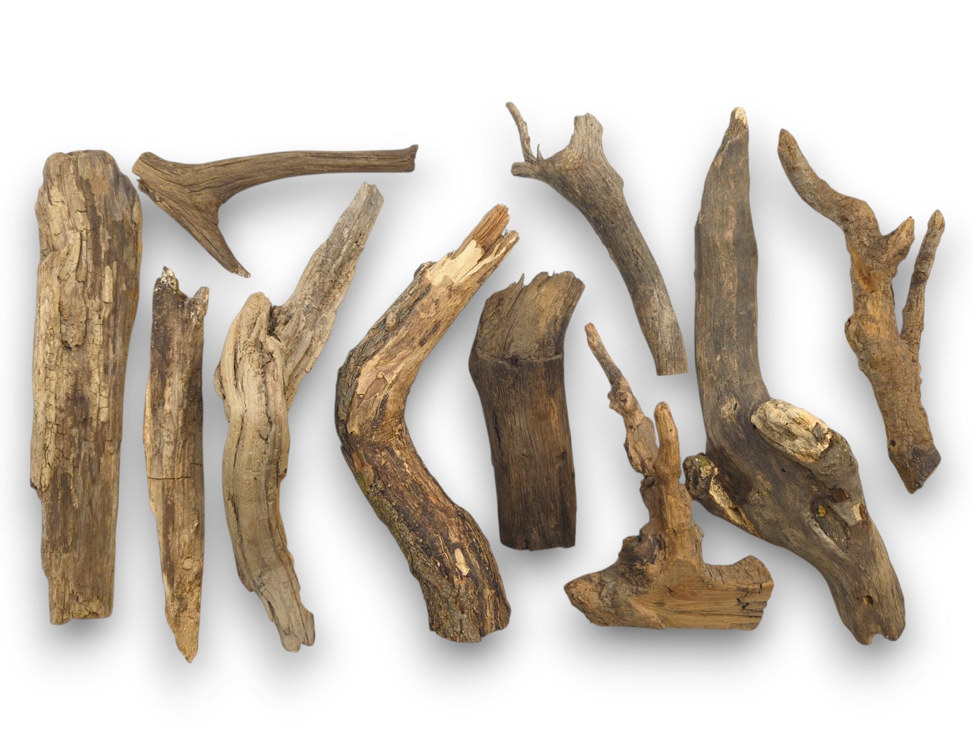 An assortment of weathered raw wood branches, displaying a variety of organic forms, knots, and textures.