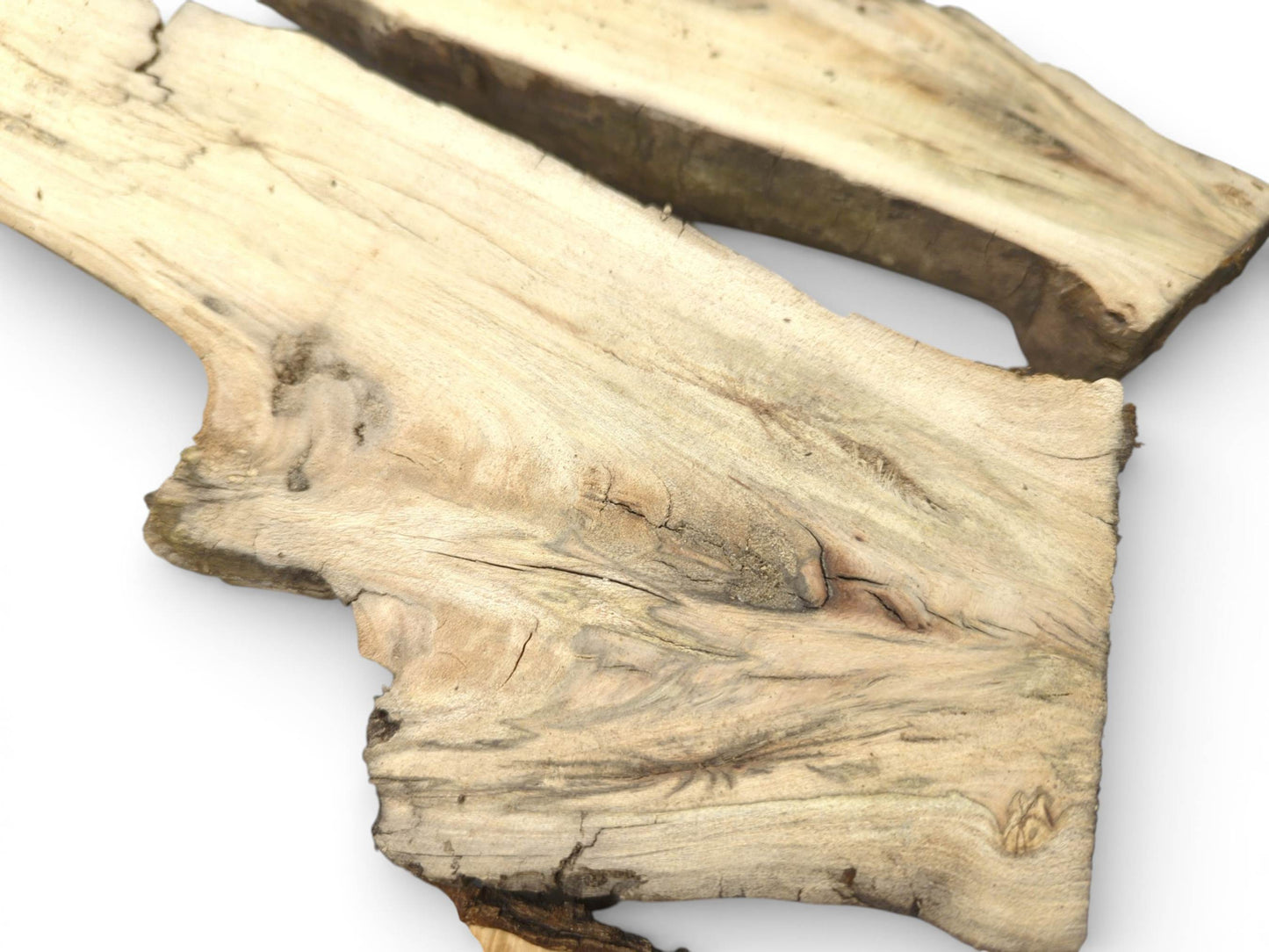 A close view of a sectioned wood slab, emphasizing its detailed, marbled grain and natural, uneven edge.
