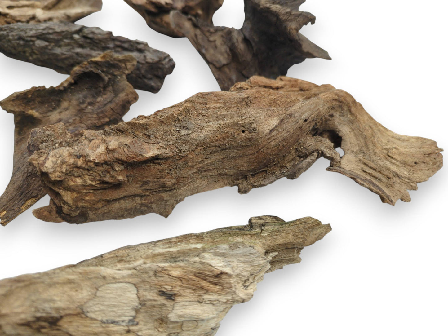 A detailed, angled shot of multiple raw wood chunks, highlighting their rugged and fibrous surface details.