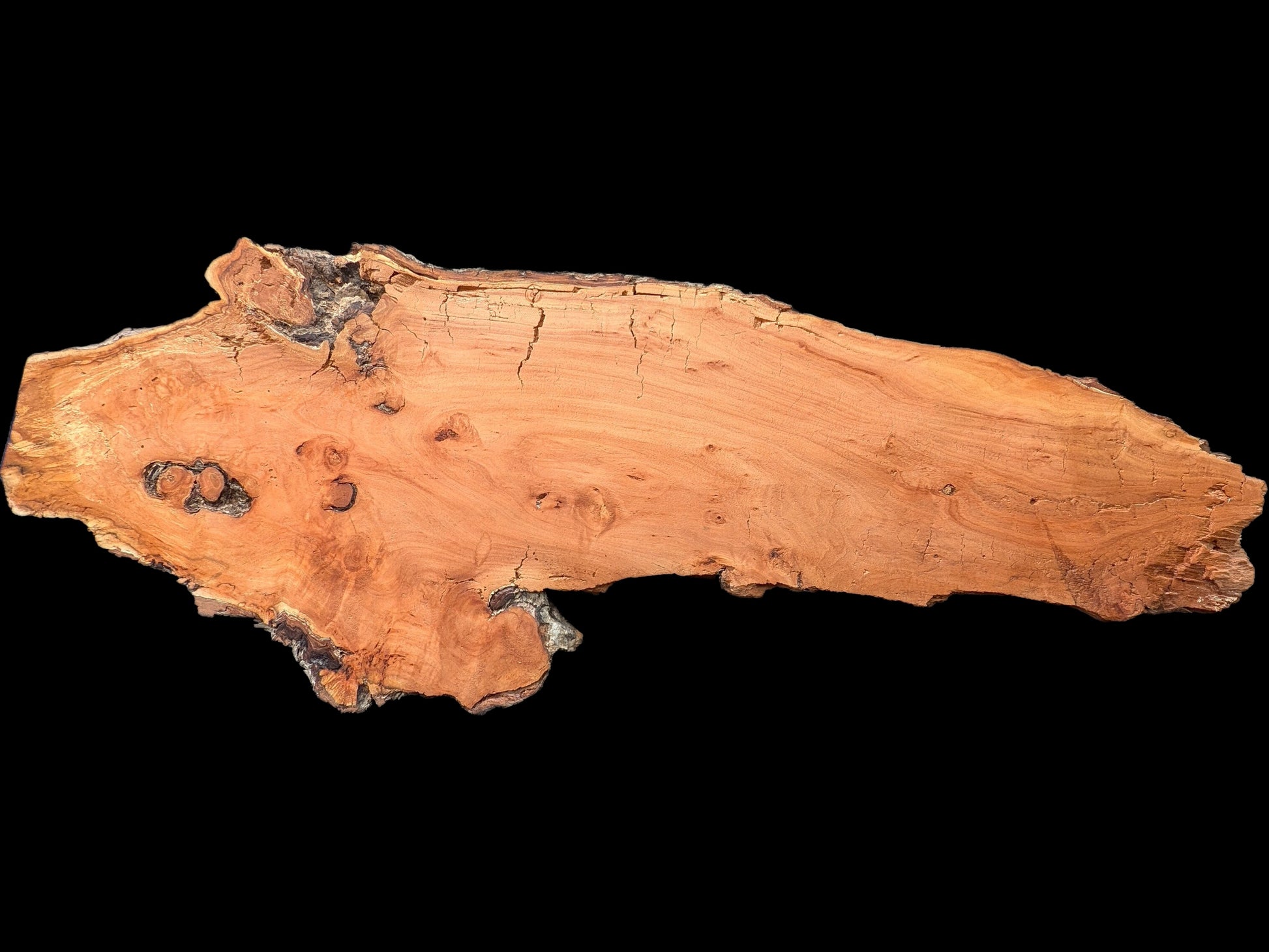 Irregular reddish-brown weeping willow wood slab with natural edges, visible grain, and surface cracks on a black background.