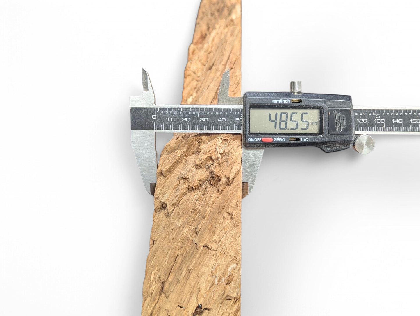 A light brown weeping willow slab with decay-like texture is measured by digital calipers displaying 48.55mm.