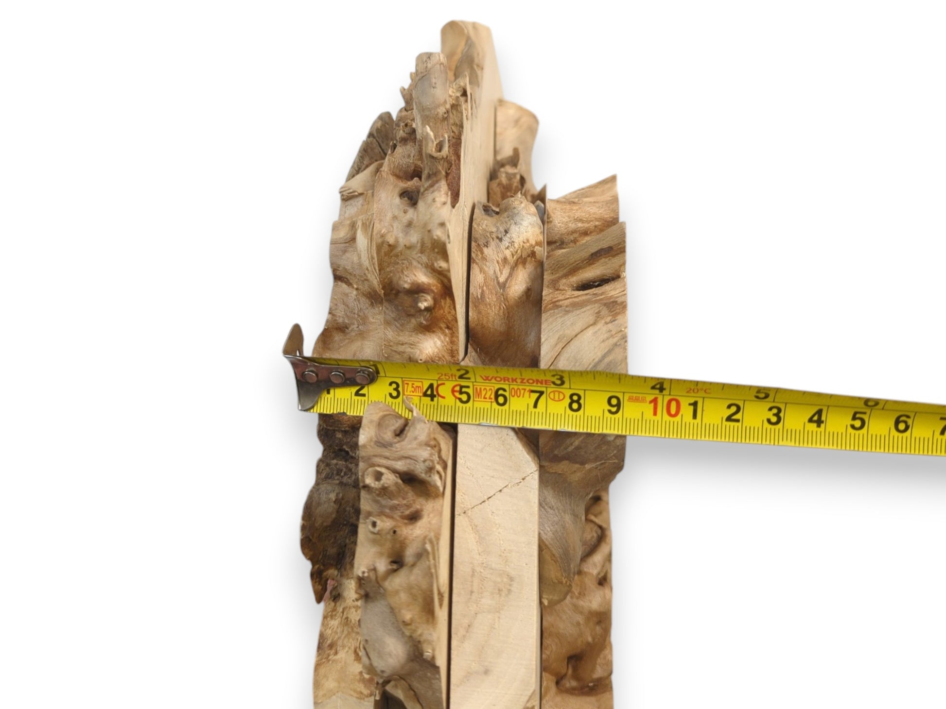 A yellow tape measure crosses four vertically aligned timber slabs with gnarled, bumpy edges.