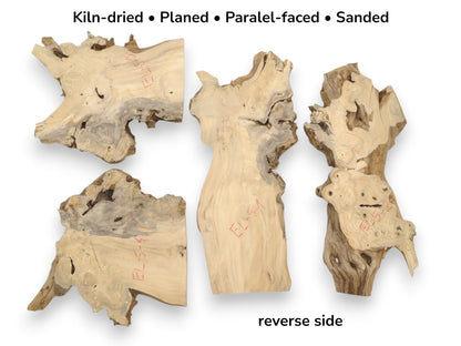 The reverse faces of four pale, planed wood slabs show rugged contours and red notations.