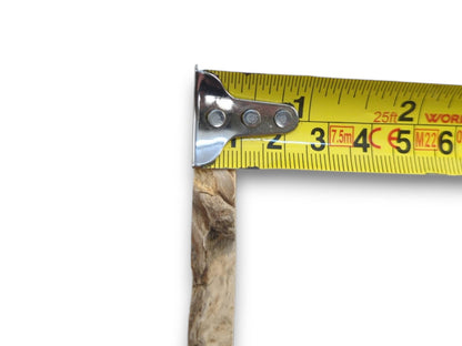 A light brown elderberry wood piece with natural bark edges measured by a yellow tape.