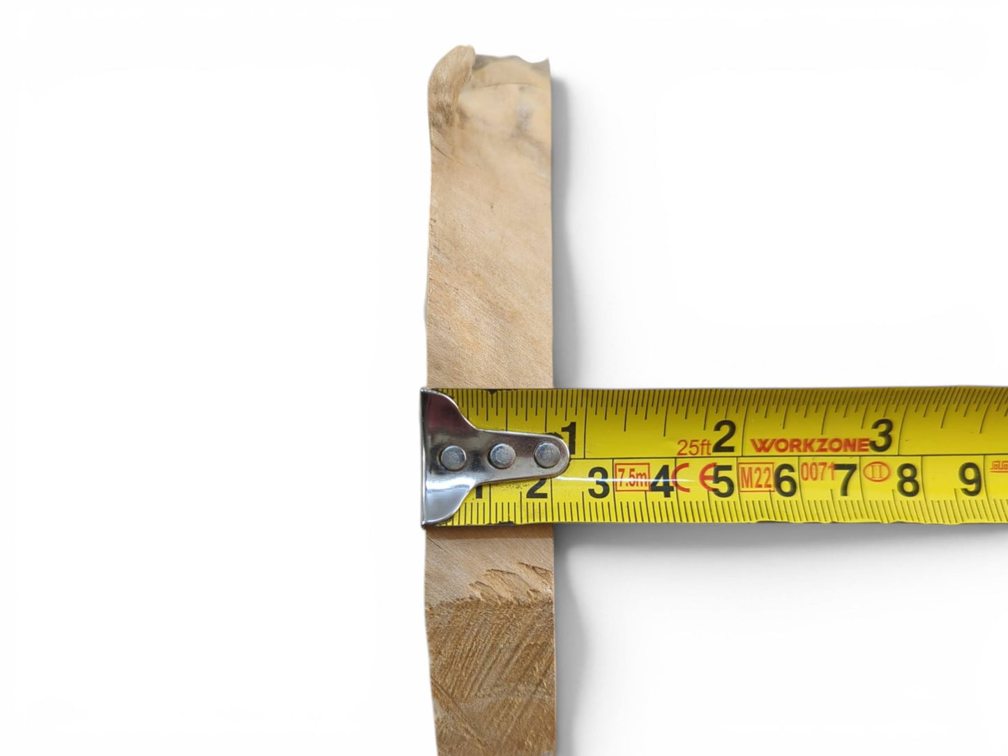 A light-colored elderberry wood piece with a natural edge, measured by a yellow tape.