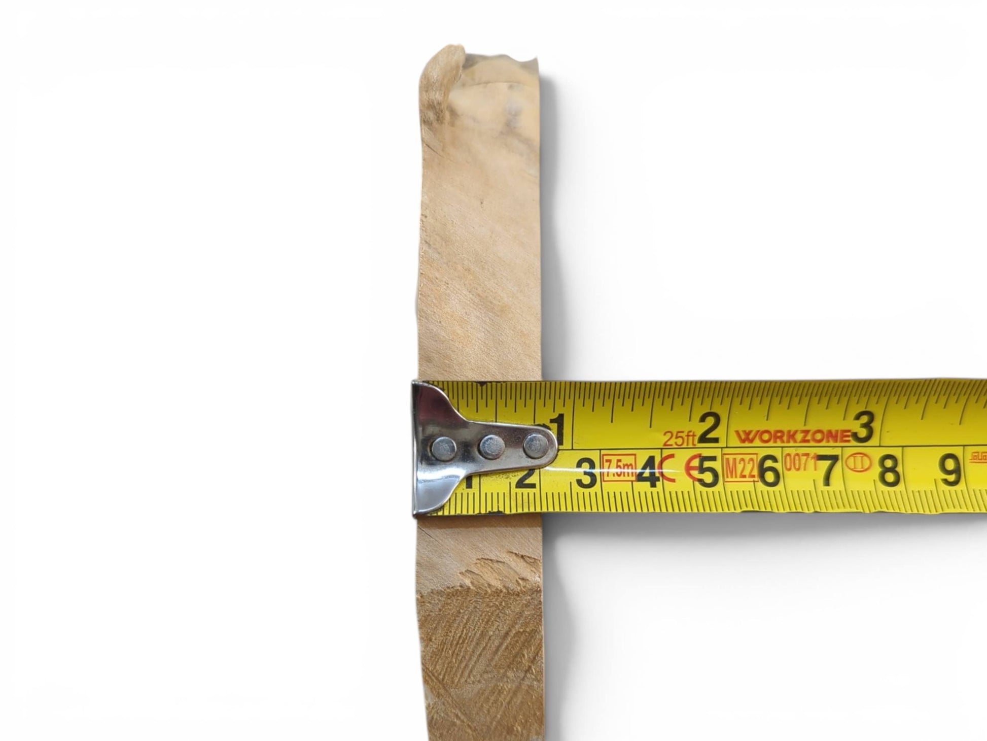 A light-colored elderberry wood piece with a natural edge, measured by a yellow tape.