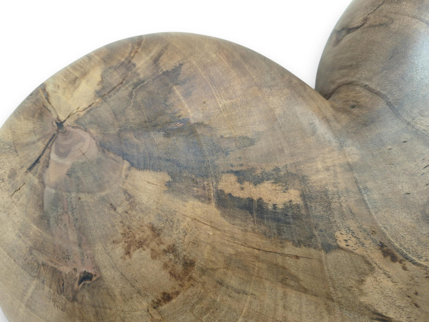 A central knot with radiating cracks anchors the circular grain of a smoothly finished timber heart.