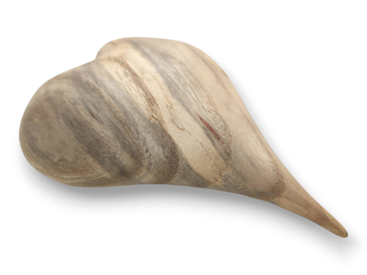 A carved lumber heart shows vertical gray grain and a small, reddish mineral streak.