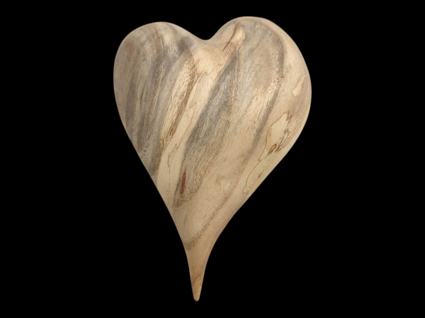 Viewed straight-on, a polished heart carving has vertical gray and brown mineral streaks.