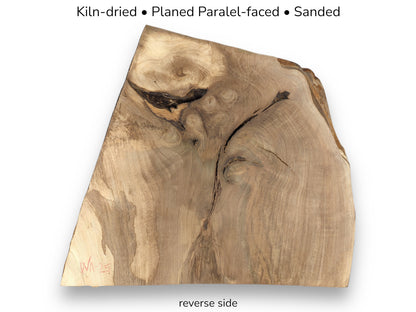 Reverse side of walnut wood featuring swirling grain, knots, and text describing kiln-dried and sanded finish.