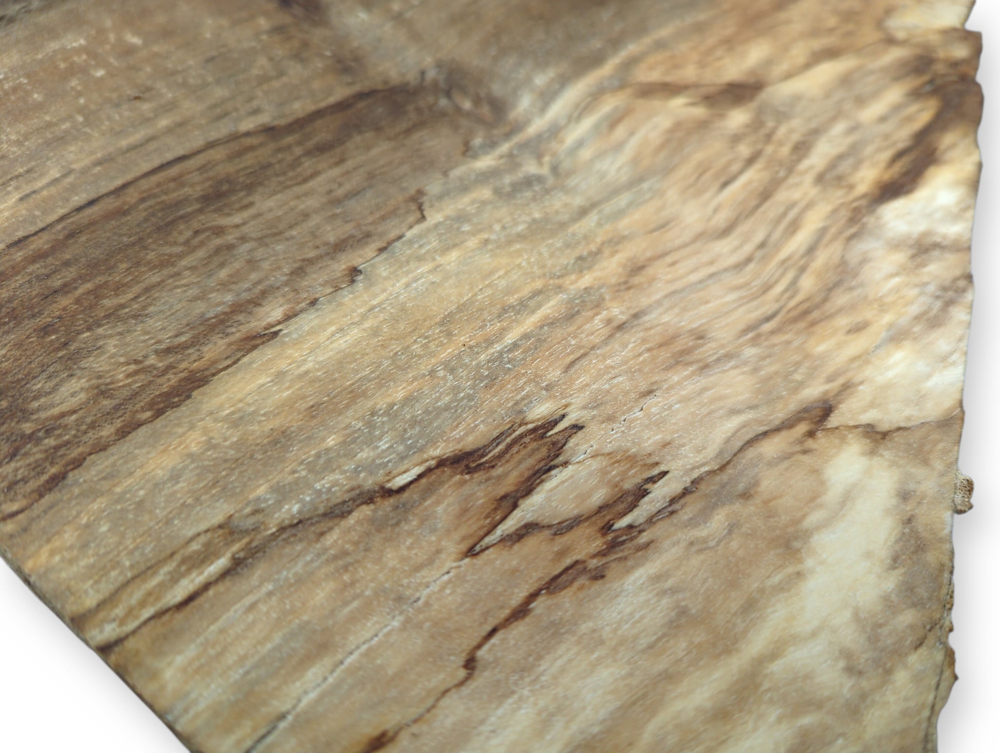 Smooth, light brown wood surface featuring prominent wavy grain patterns and dark reddish-brown streaks, with an irregular edge.